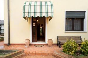 a building with awning and a bench in front of it at c.s. veniceflat Apartment - Venice - Apt Vce - 15' from Venice in Venice