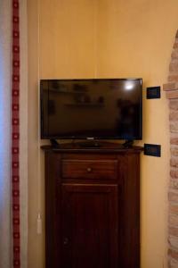 a flat screen tv sitting on top of a wooden cabinet at c.s. veniceflat Apartment - Venice - Apt Vce - 15' from Venice in Venice