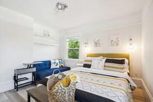 a bedroom with a bed and a blue couch at Luxury Living, Walkers Paradise, Hidden Oasis in Oakland