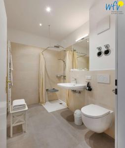 a bathroom with a toilet and a sink at Haus am Hövt - Ferienwohnung 3 in Göhren +32 photos