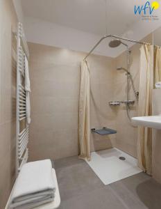 a bathroom with a shower and a sink at Haus am Hövt - Ferienwohnung 3 in Göhren