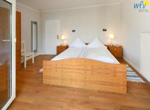 En eller flere senge i et værelse på Haus am Hövt - Ferienwohnung 8