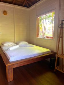 a bed in a room with a window at Ti Kaz Açaï in Le Lamentin