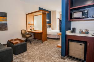 a hotel room with a bed and a living room at Springhill Suites by Marriott San Antonio Alamo Plaza/Convention Center in San Antonio