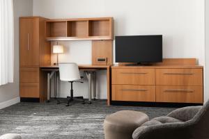 an office with a desk with a tv and a chair at TownePlace Suites by Marriott Sacramento Roseville in Roseville