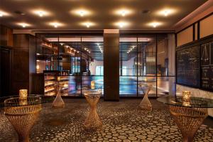 a room with several tables and glass vases at Hotel EMC2, Autograph Collection in Chicago