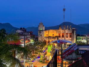 an old building with a clock tower at night at Grann Posada Xilitla in Xilitla