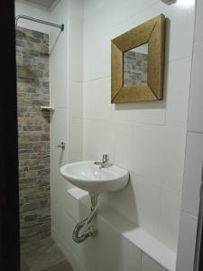 uma casa de banho com um lavatório e um espelho na parede em Quinta Guairabamba em Melgar