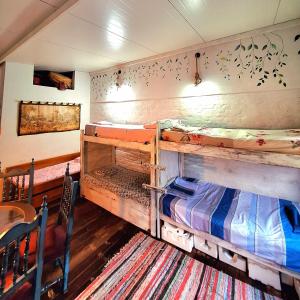 two bunk beds in a room with a table at La Petite Maison in Asunción