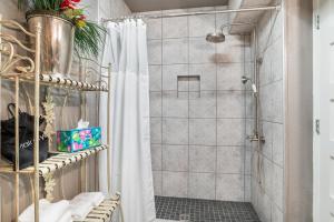 a shower with a shower curtain in a bathroom at Salt Block - French Serenity Suite 3 in Bandera +10 photos