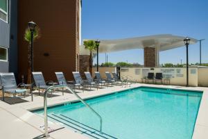 a swimming pool with lounge chairs at Fairfield Inn & Suites by Marriott San Diego North/San Marcos in San Marcos