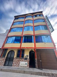 a building with blue windows on the side of it at Hotel Elegant in Cajamarca