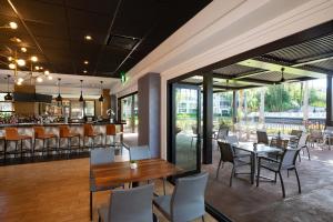 a restaurant with tables and chairs and a bar at Sheraton Vistana Villages Resort Villas, I-Drive Orlando in Orlando