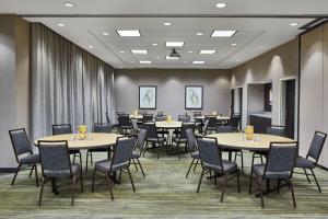 a conference room with tables and chairs in it at Fairfield Inn & Suites by Marriott Atlanta Lithia Springs in Lithia Springs