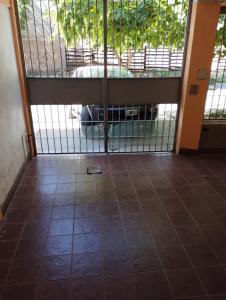 an open gate in a room with a car behind it at Departamento West in Las Heras