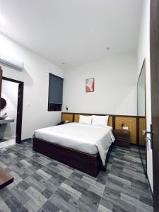 Postel nebo postele na pokoji v ubytování De V’Charm Hotel