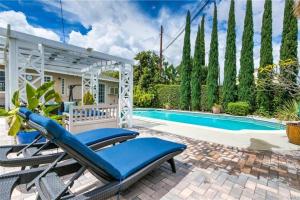 a house with a swimming pool and a patio with a chaise lounge at Resort style home, Pool/Spa/Game room near Disney in Anaheim