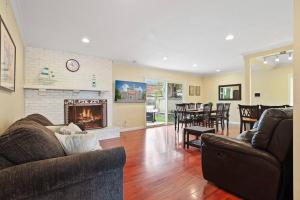 a living room with a couch and a fireplace at Resort style home, Pool/Spa/Game room near Disney in Anaheim