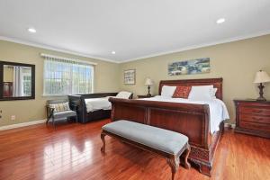 a large bedroom with a bed and a couch at Resort style home, Pool/Spa/Game room near Disney in Anaheim +25 photos