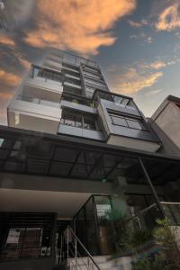 a building with a lot of windows on it at Sonata 44 Hotel Laureles in Medellín
