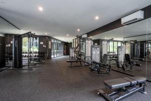 a gym with cardio equipment and mirrors in a building at Panoramic Lake View 2-Bed with Pool, Gym and BBQ in Belconnen