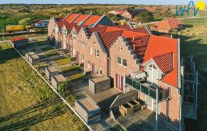 an overhead view of a house with orange roofs at Haus Kiek in't Watt- Ferienwohnung Quartier 7 Ost in Juist