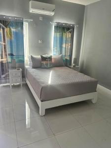 a bedroom with a large bed in a room at CLIFF POINT in Treasure Beach