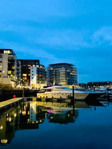 a boat is docked in a marina at night at SUPERYACHT ON 5 STAR OCEAN VILLAGE MARINA, SOUTHAMPTON - minutes away from city centre and cruise terminals - free parking included in Southampton