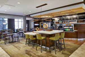 a restaurant with a bar with chairs and tables at Courtyard by Marriott Atlanta Lithia Springs in Lithia Springs