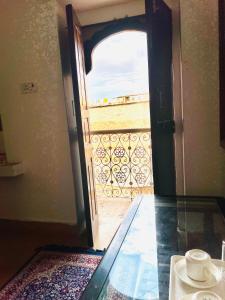 an open door with a view of a balcony at Hotel Dara & Camel Safari in Jaisalmer