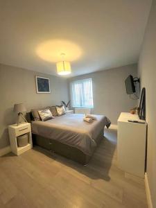 a bedroom with a large bed and a window at Modern Apartment In The Heart Of Kensington in Liverpool