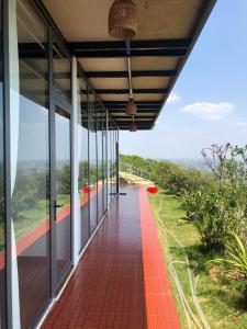 a view of a house with a red brick walkway at Doi Hoa Do Homestay in Bao Loc