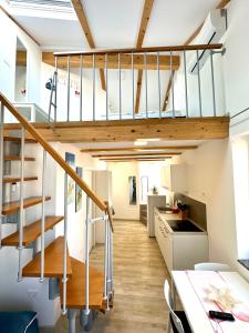 a staircase in a loft conversion with wooden floors at Old Piran Starfish in Piran