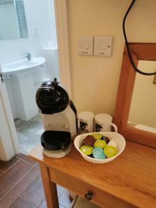 a mixer on a table next to a bowl of eggs at The Brownlow Stables in Leighton Buzzard