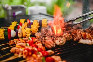 a grill with meat and other food on it at Hotel Stripes Kuala Lumpur, Autograph Collection in Kuala Lumpur