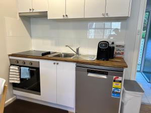 a kitchen with a sink and a counter top at One-Bedroom Apartment on Summer in Orange