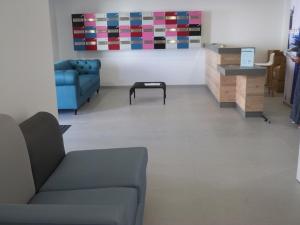 a living room with a couch and a table at Appartement 2 ch, accès plage direct, rez-de-jardin, piscine, animaux OK - FR-1-194-284 in La Tranche-sur-Mer