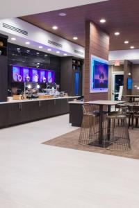 a lobby with a table and chairs in a building at SpringHill Suites by Marriott Birmingham Gardendale in Gardendale