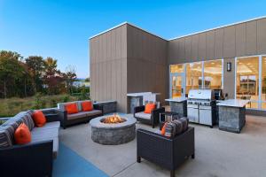 a patio with couches and a fire pit and a kitchen at TownePlace Suites by Marriott Edgewood Aberdeen in Belcamp