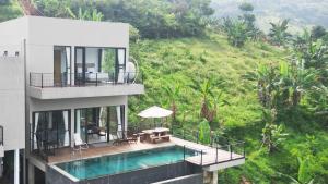 a building with a swimming pool and a balcony at Thalassaville Dago Bandung in Bengkok