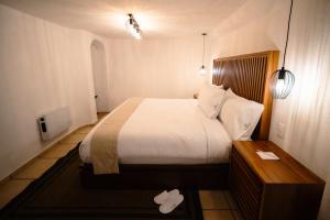 a hotel room with a bed and a table at BOTANIQ HOTEL BOUTIQUE in Valle de Bravo
