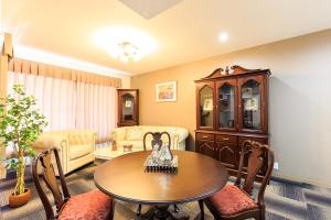 a living room with a table and a couch at #10 Nagoya Sunflower Condominium in Yadachō