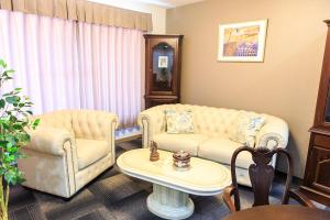 a living room with two couches and a table at #10 Nagoya Sunflower Condominium in Yadachō