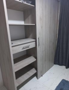 a closet with wooden shelves in a room at Hostel Campoamor in Medellín