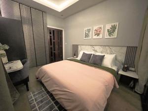 a bedroom with a large white bed and a desk at 356 Hostel in Thung Song