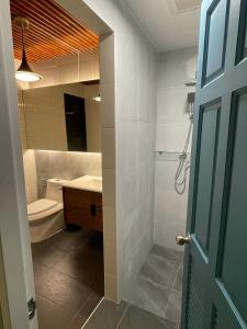a bathroom with a sink and a toilet and a mirror at 356 Hostel in Thung Song