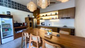 a kitchen with a large wooden table and chairs at Leafy Home Canggu in Canggu
