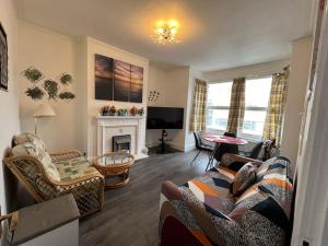 a living room with a couch and a fireplace at *Your Home at Southend on Sea* in Southend-on-Sea