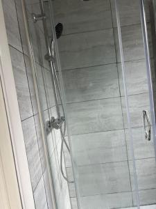 a shower in a bathroom with a glass door at *Your Home at Southend on Sea* in Southend-on-Sea