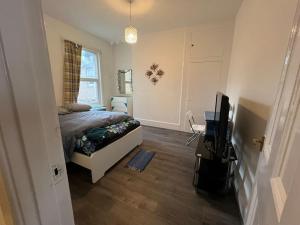 a bedroom with a bed and a television in it at *Your Home at Southend on Sea* in Southend-on-Sea